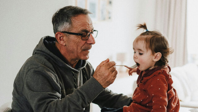 Grandparent with child feeding