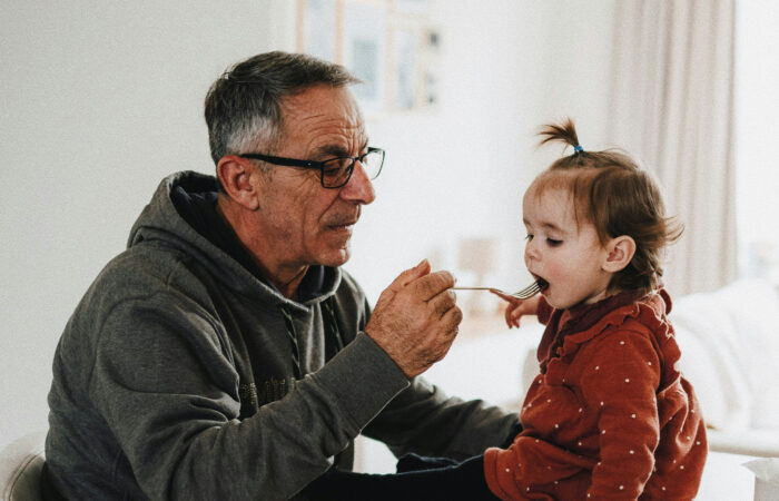 Grandparent with child feeding